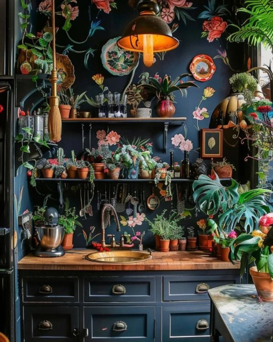 Dark green kitchen cabinets with wooden countertops and many potted indoor plants on shelves