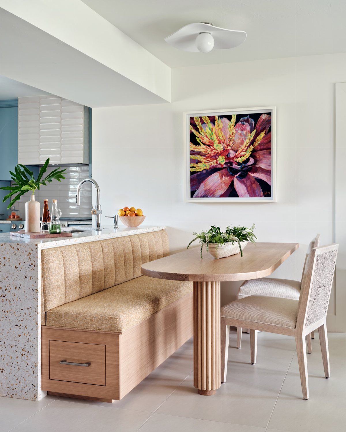 Built-in wooden breakfast nook bench with a storage drawer and matching table.