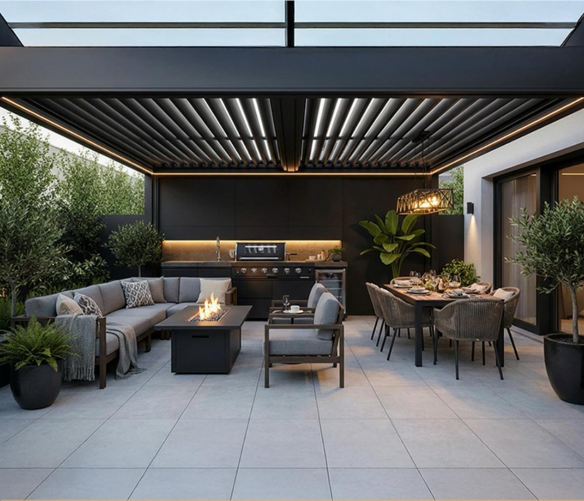 Modern outdoor patio featuring a black louvered roof over a kitchen and lounge area.