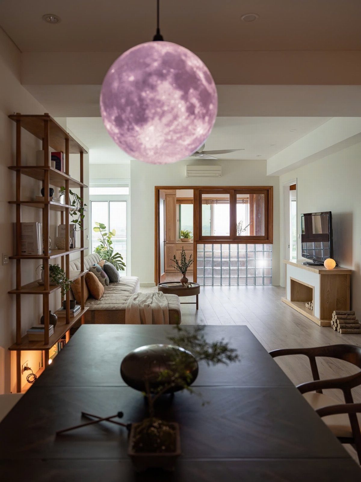 Modern Japanese interior with a moon pendant lamp and dark wood dining table