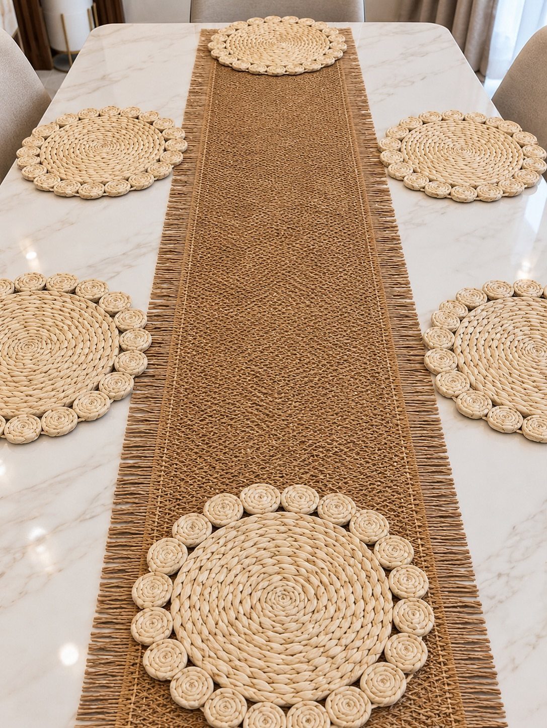 Woven straw table runner and circular placemats on a white marble dining table.