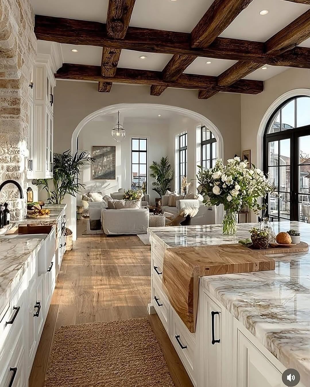 Dark rustic exposed wood beams on a white ceiling in a farmhouse kitchen