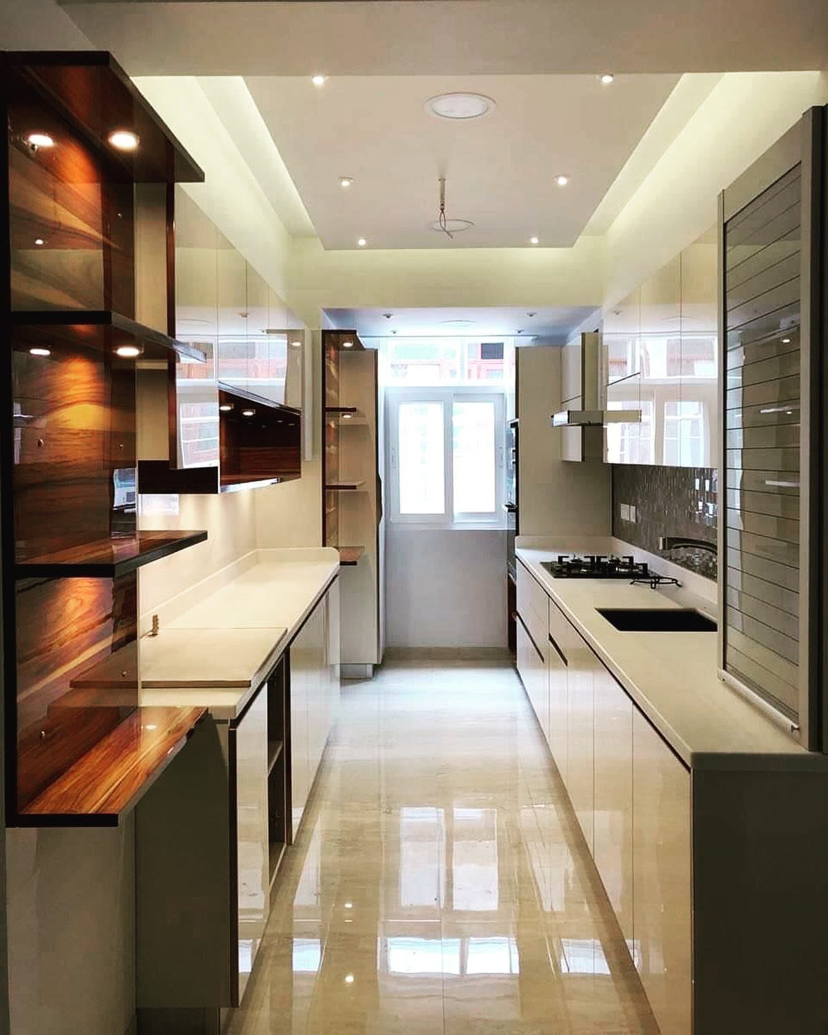 Galley kitchen with parallel white countertops, dark wood shelving, and polished tile floors.