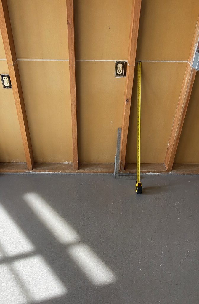 Chalk line marked on the wall for vertical sliding shelves layout.